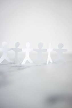 manpower and teamwork conceptual image, paper people chain with text on white marble background
