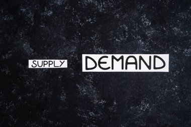 small Supply text and big Demand text on dark background, concept of supply chain shortages and delays after the covid-19 global pandemic
