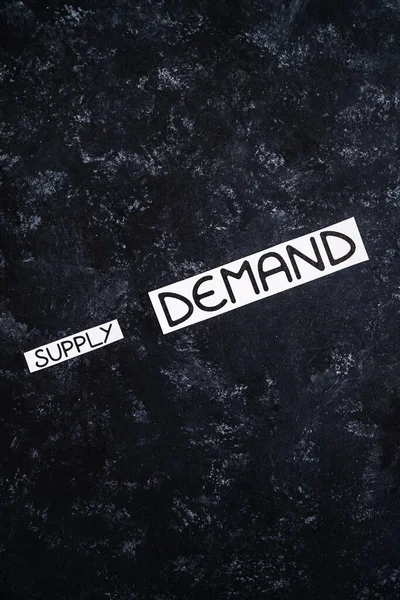 small Supply text and big Demand text on dark background, concept of supply chain shortages and delays after the covid-19 global pandemic