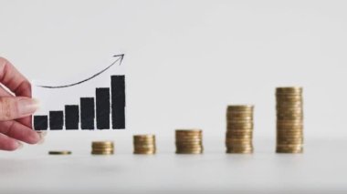 rising inflation graph in front of growing stacks of coins representing increasingly expensive prices, concept of global economy struggling after the covid-19 pandemic