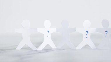 staff shortages and hiring personnel conceptual image, paper people chain with question marks on some people symbol of positions to be filled