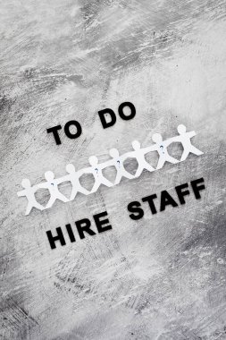 staff shortages and workforce conceptual image, To Do Hire Staff text with paper people chain and question marks on vacant positions to fill