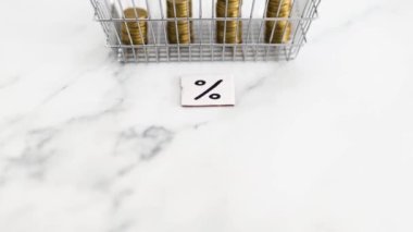 prices going up and rising inflation concept with percentage symbol in front of shopping basket with growing stacks of coins inside of it, global economy struggling after the covid-19 pandemic