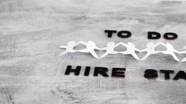 staff shortages and workforce conceptual image, To Do Hire Staff text with paper people chain and question marks on vacant positions to fill