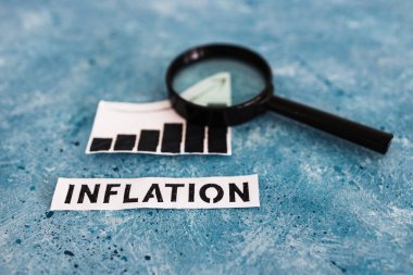Enflasyon metni ve grafiği fiyatların yükseldiğini gösteriyor. Büyüteç analizi istatistikleri, salgından sonraki ekonomik mücadele kavramı.