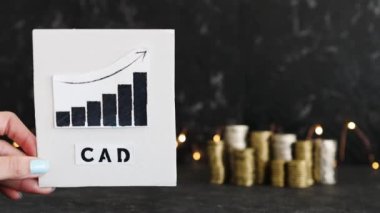 Döviz kuru kavramsal görüntü, grafik para yığınlarının önünde CAD Kanada Doları metni ile pozitif büyüme gösteriyor