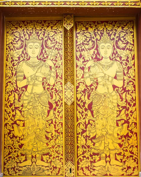 Arte antiga tailandesa Pintura de anjo de ouro na porta do templo — Fotografia de Stock