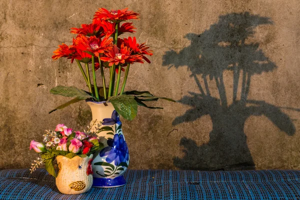 Stilleben - plast-blomma i vasen med skugga — Stockfoto