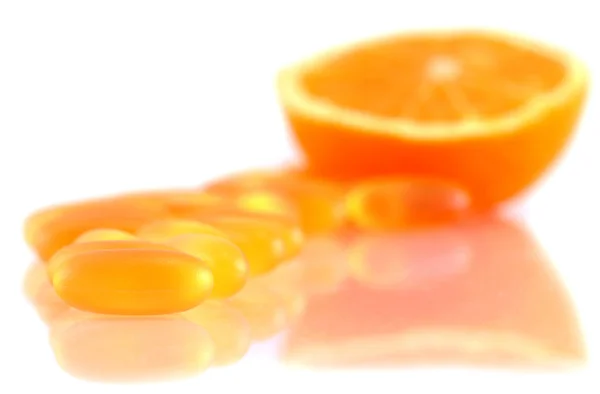 Shiny yellow vitamin e fish oil capsule isolated on white backgr — Stock Photo, Image