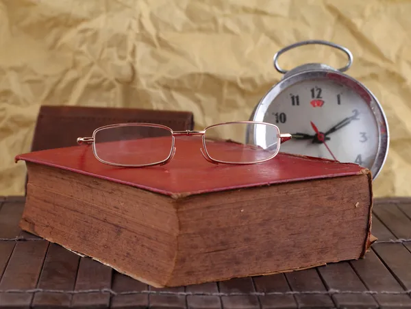 Old book with Eye glass and clock