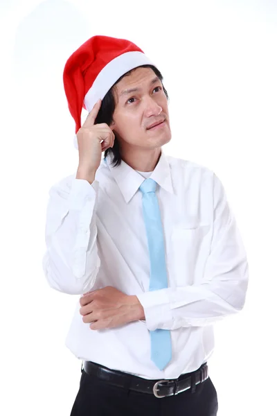 Joven con sombrero de Santa Claus y algo sobre fondo blanco . — Foto de Stock