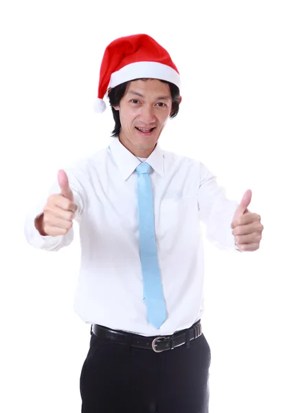 Młody człowiek ubrany kapelusz Świętego Mikołaja i uśmiechając się. — Zdjęcie stockowe