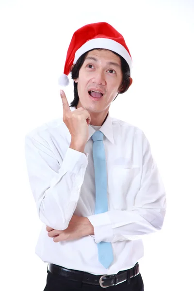 Giovane uomo che indossa un cappello di Babbo Natale e cosa su sfondo bianco . — Foto Stock