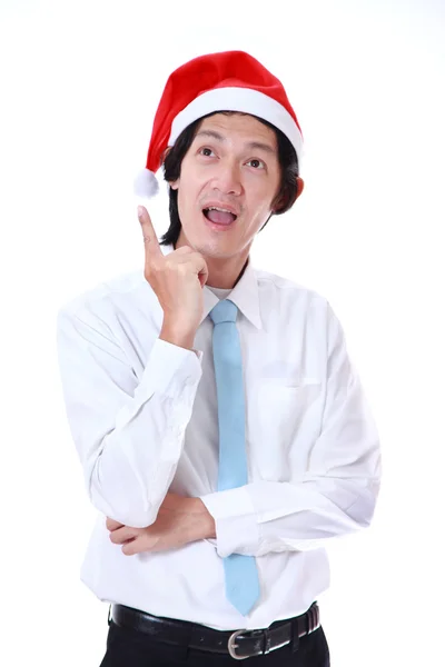 Joven con sombrero de Santa Claus y algo sobre fondo blanco . — Foto de Stock