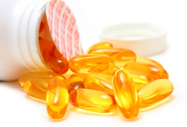 Fish oil capsules and container — Stock Photo, Image