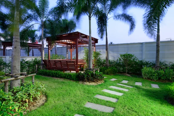 Cottage in the garden at night — Stock Photo, Image