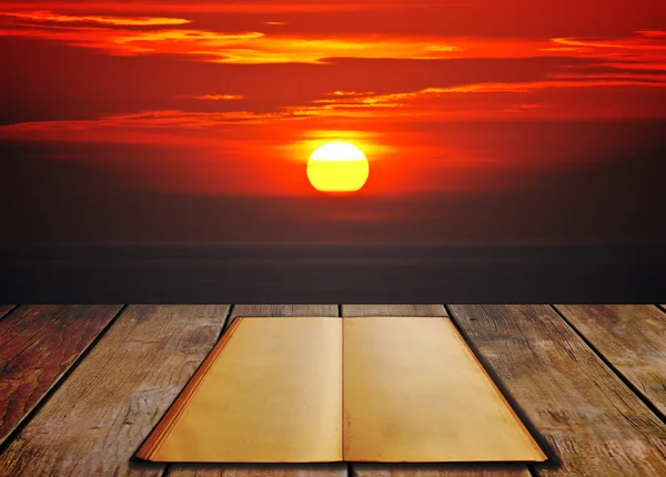 Buch auf Holzboden mit Sonnenuntergang — Stockfoto