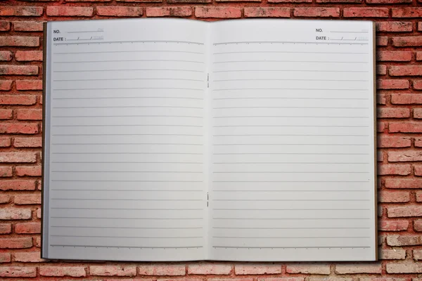 Notebook on the brickwall — Stock Photo, Image