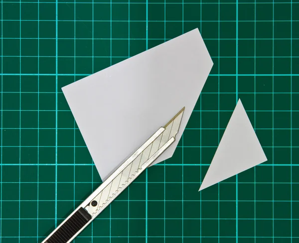 Cutter Knife Cutting white paper on cutting mat