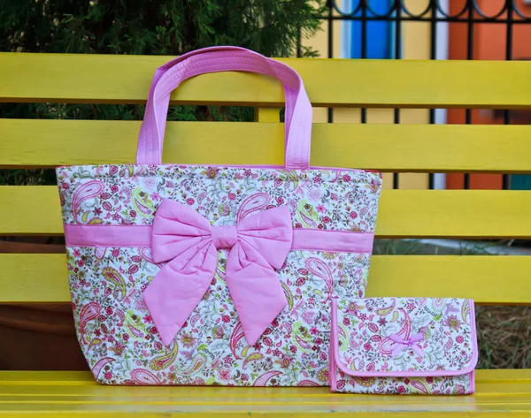 Luxury women bag on table in garden — Stock Photo, Image