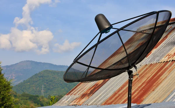 Satellite dish with sky on roof — Stock Photo, Image