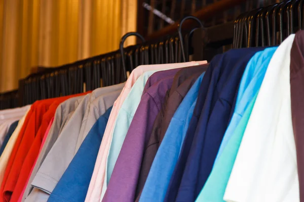 Colors of rainbow. Variety of casual shirts on hangers — Stock Photo, Image