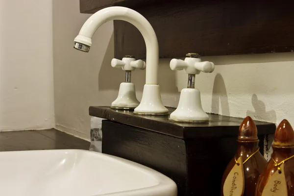 Silver chrome bathroom tap faucets running water in a sink — Stock Photo, Image