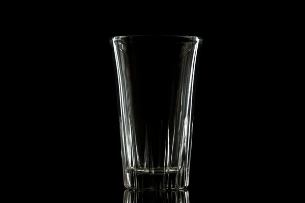 Empty glass on a black isolated background — Stock Photo, Image