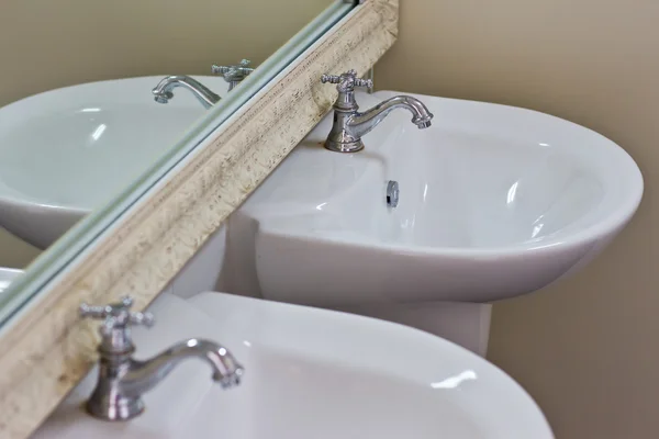 Silver chrome bathroom tap faucets running water in a sink — Stock Photo, Image