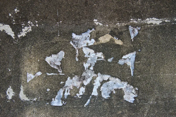 Torn white paper on the old dark brick wall — Stock Photo, Image