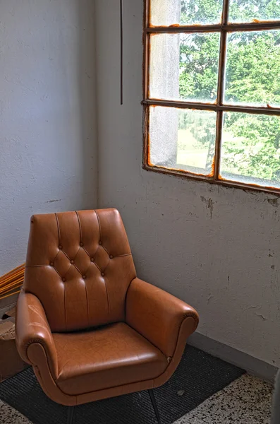 Old fashioned leather armchair and a window — Stock Photo, Image