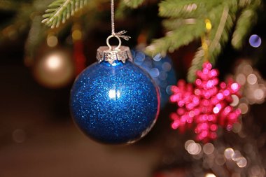 Blue balloons hanging on the Christmas tree