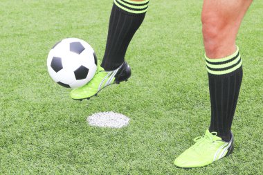 Soccer ball with foot of player kicking it