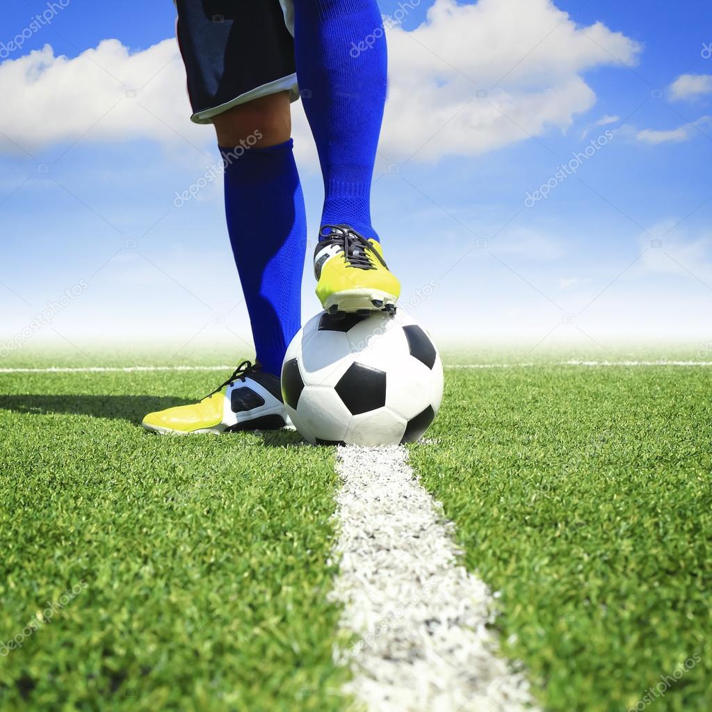 soccer ball with feet player on the football field