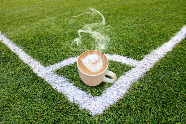 Hot coffee on green grass — Stock Photo, Image