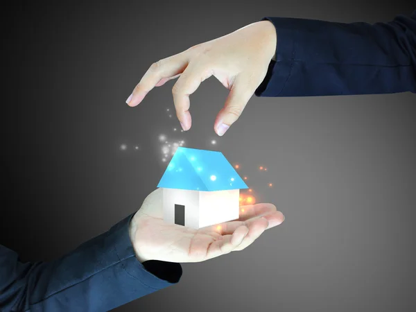 Concept image of a hand holding house — Stock Photo, Image