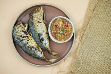 Karides ezmesi soslu iki kızarmış uskumru.