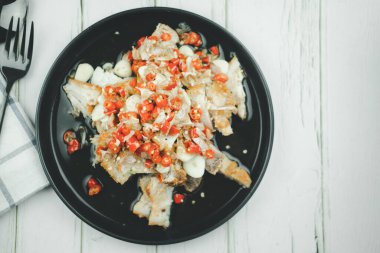 Crispy pork with lime garlic and chili, is popular as appetizer in Thailand. Top view