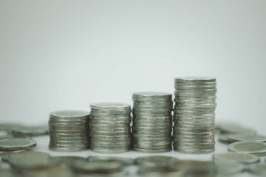 Four stacks of coins are arranged as a graph. Profit and business investment growth concept.