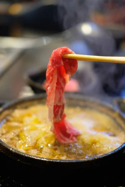 Hand Using Chopsticks Pick Raw Sliced Beef Eating Shabu Shabu — Stock Photo, Image