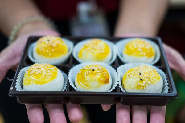 Chinese pastry moon cake in box on hand. Delicious bakery ready to served.