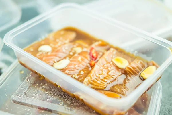 在透明的塑料盒中加入鲑鱼腌制或鲑鱼腌制的韩式酱油 — 图库照片