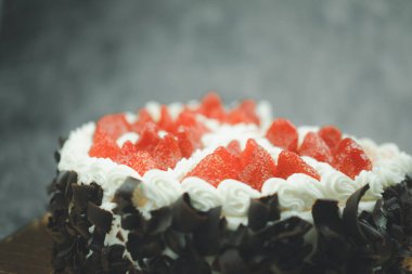 Üstünde çilek olan vanilyalı doğum günü pastası. Kapat.