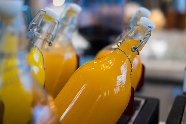 Fresh orange juice in bottles on buffet line, buffet self service in morning at hotal
