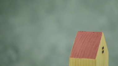 Rotate of miniature wood house. Real estate home mortgage or buying concept. Business financial and loan