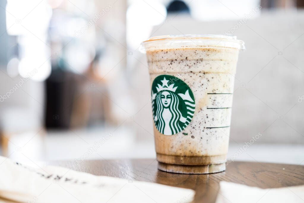Bangkok, Samut Prakan - May 29, 2022 : A glass of Almondmilk White Chocolate Affogato Frappuccino from Starbucks coffee. Starbucks is the world's largest coffeehouse and is highly popular