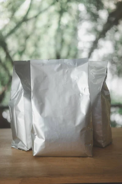 Foil paper bag package of coffee beans. Retail shopping and advertising concept