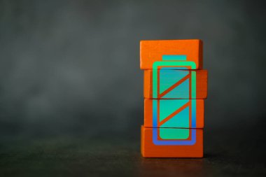 Full charged battery green icon on wood block, Close up and copy space