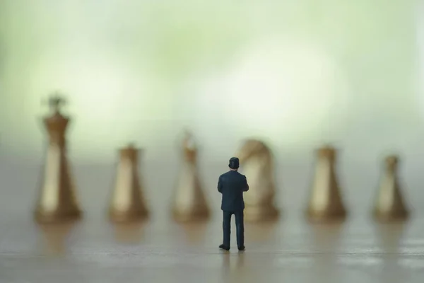 Back View Miniature Businessman Watching Golden Chess Negotiating Business Background — Fotografia de Stock