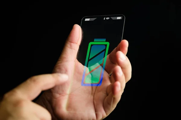 Hand touch a transparent glass phone with an icon a technology charging the wireless battery on a black background.
